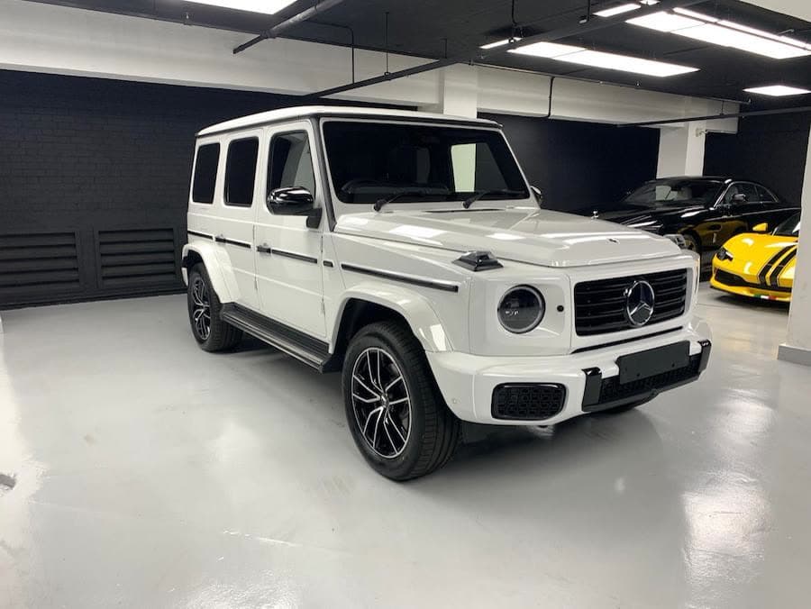 White Mercedes-Benz G500 in a showroom
